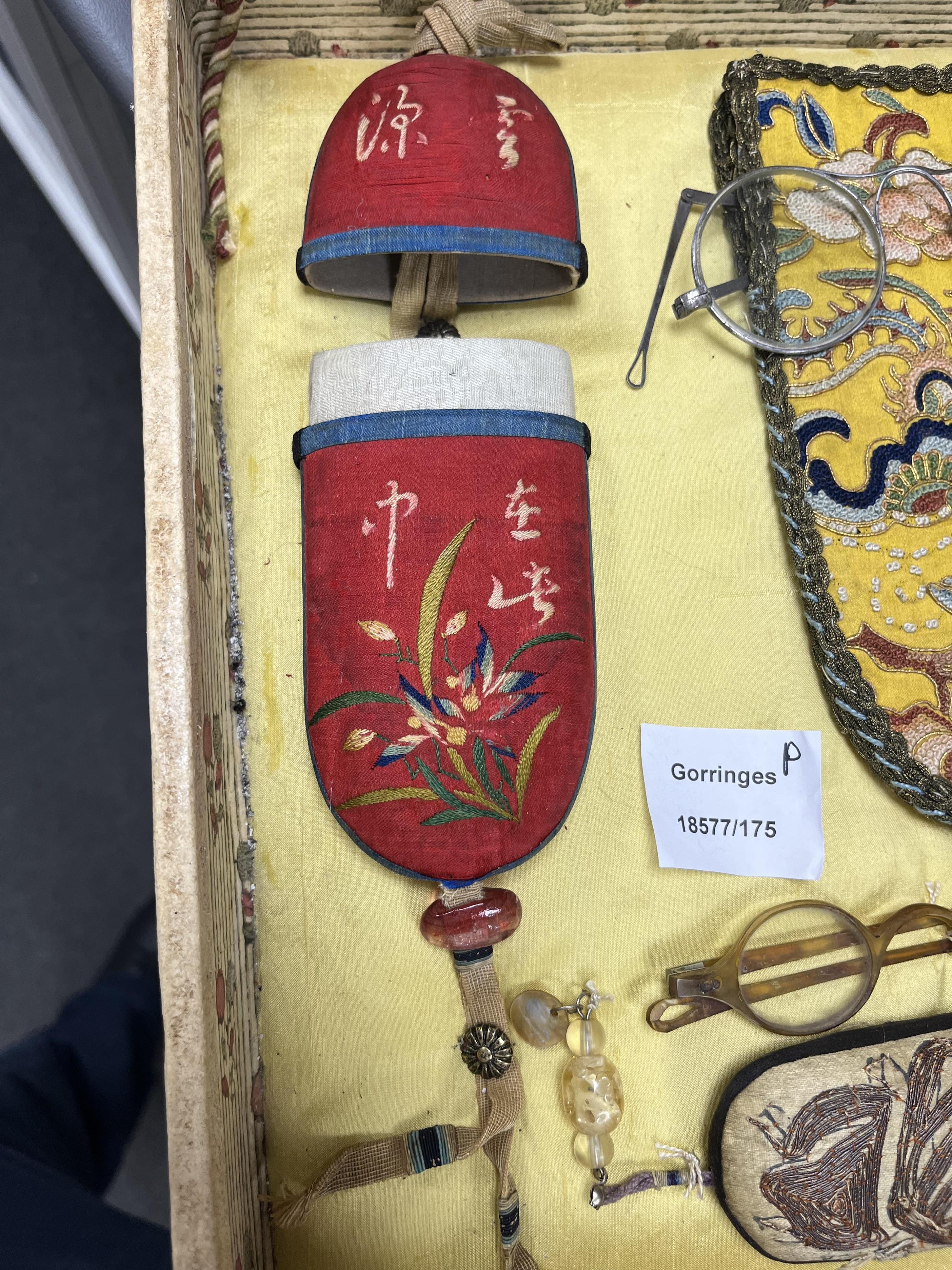 A collection of 19th/20th century Chinese embroidered silk spectacle cases and various spectacles, Box 33cm square